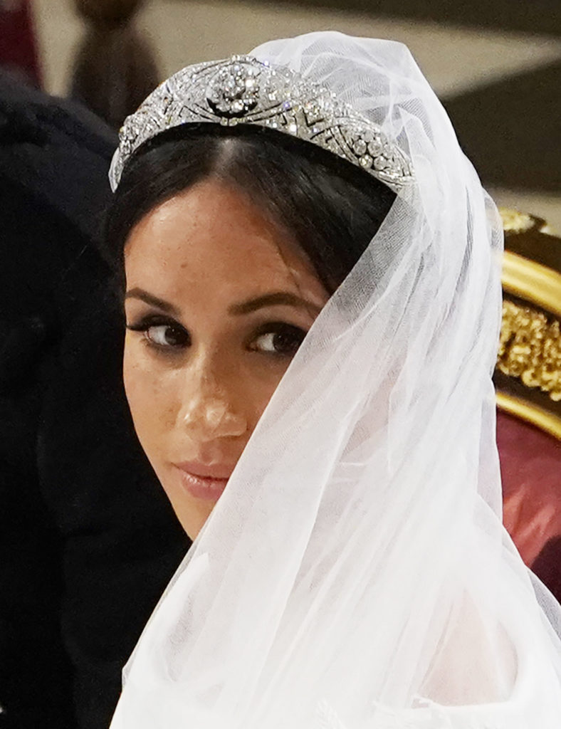 Meghan glances over her shoulder in St George's Chapel at Windsor Castle