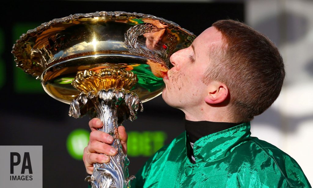 Jockey receiving a prize in an official photo for The Jokey Club