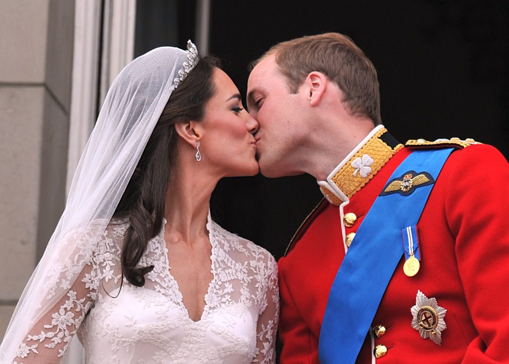 The Duke and Duchess of Cambridge kiss on the balcony of Buckingham Palace after their wedding on 29 April, 2011. Picture by John Stillwell, PA